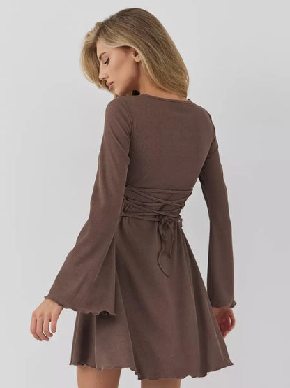 Elegant brown long sleeve mini dress with flared cuffs and chest cut-out, featuring a flattering A-line silhouette.