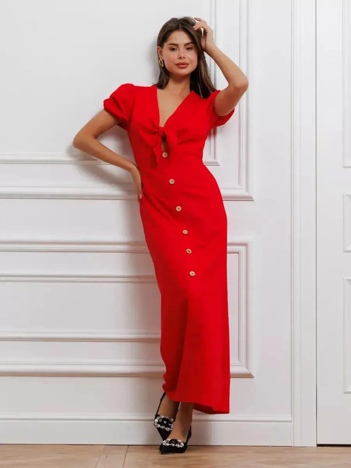 Bold red maxi dress with tie-front detail and puff sleeves for a romantic and sophisticated look.