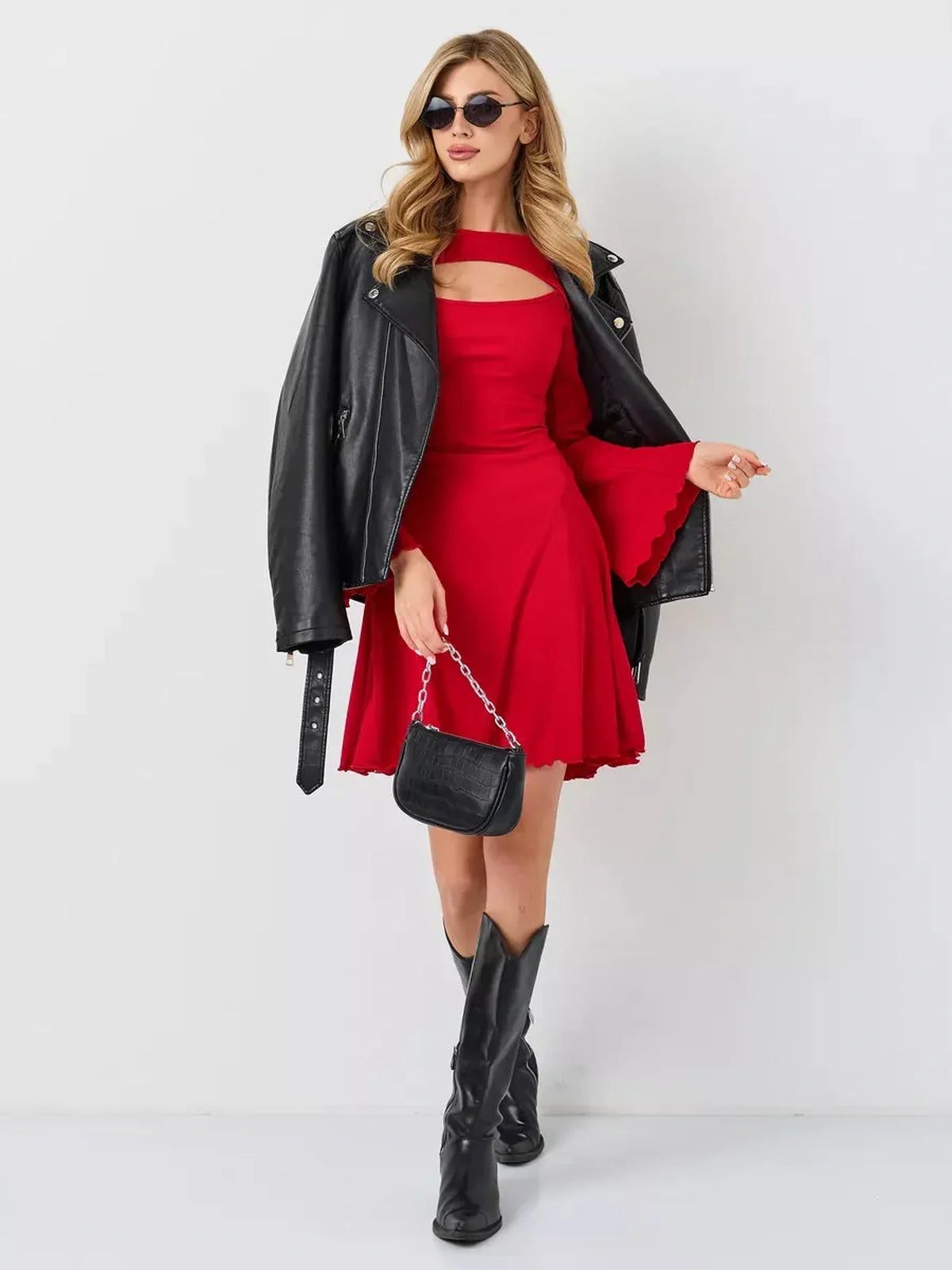 Model wearing a red Flare Cutout Mini dress with a black leather jacket and accessories, showcasing modern style and flair.