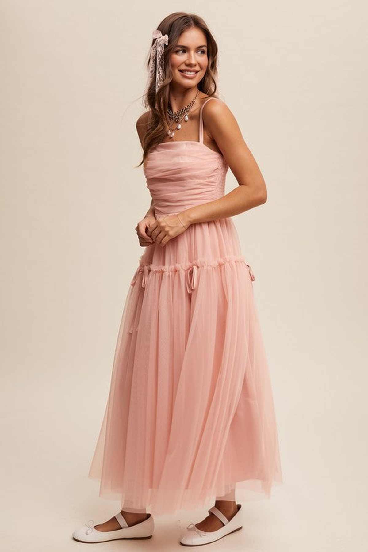 Elegant pink maxi dress with soft mesh overlay, perfect for weddings and formal events.