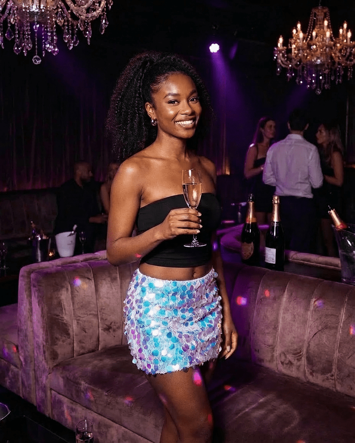 Celeste Mini Skirt by Lauven worn at a party, showcasing blue iridescent sequins and a bodycon silhouette.