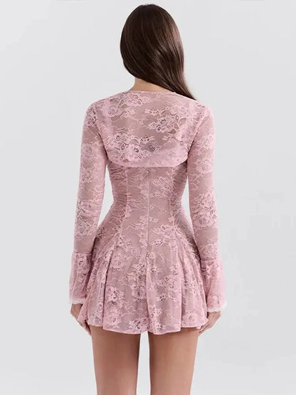 Back view of a pink lace Adele Mini Dress featuring long sleeves and a flared skirt, perfect for summer events.
