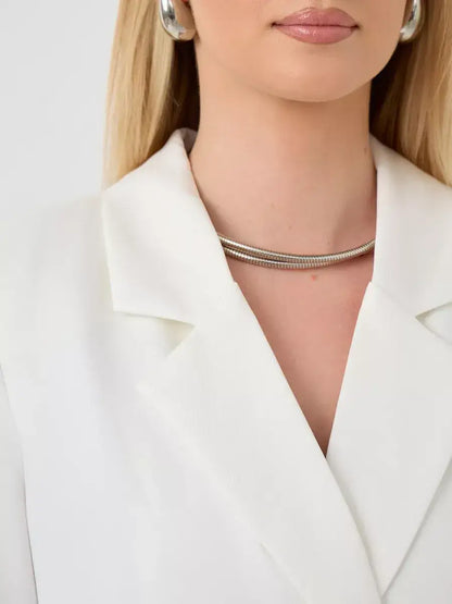 Close-up of a woman wearing the Alabaster Blazer by Lauven, showcasing a modern oversized design in crisp white.