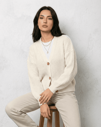 Alba Cardigan by Lauven – Classic white knitwear with a soft V-neck and button detail, perfect for layering.