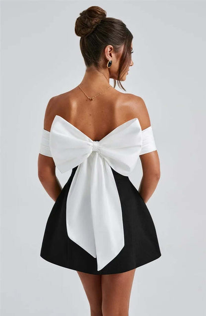 Elegantly designed Alba Mini Dress featuring an oversized white bow and off-shoulder satin neckline, perfect for special occasions.