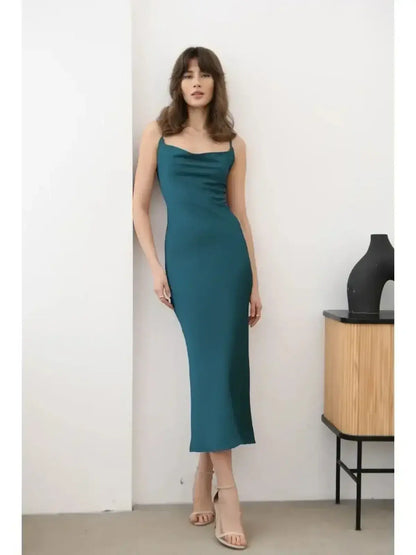Model wearing the Allure Midi Dress in emerald green, featuring a sleek silhouette and satin-like texture.