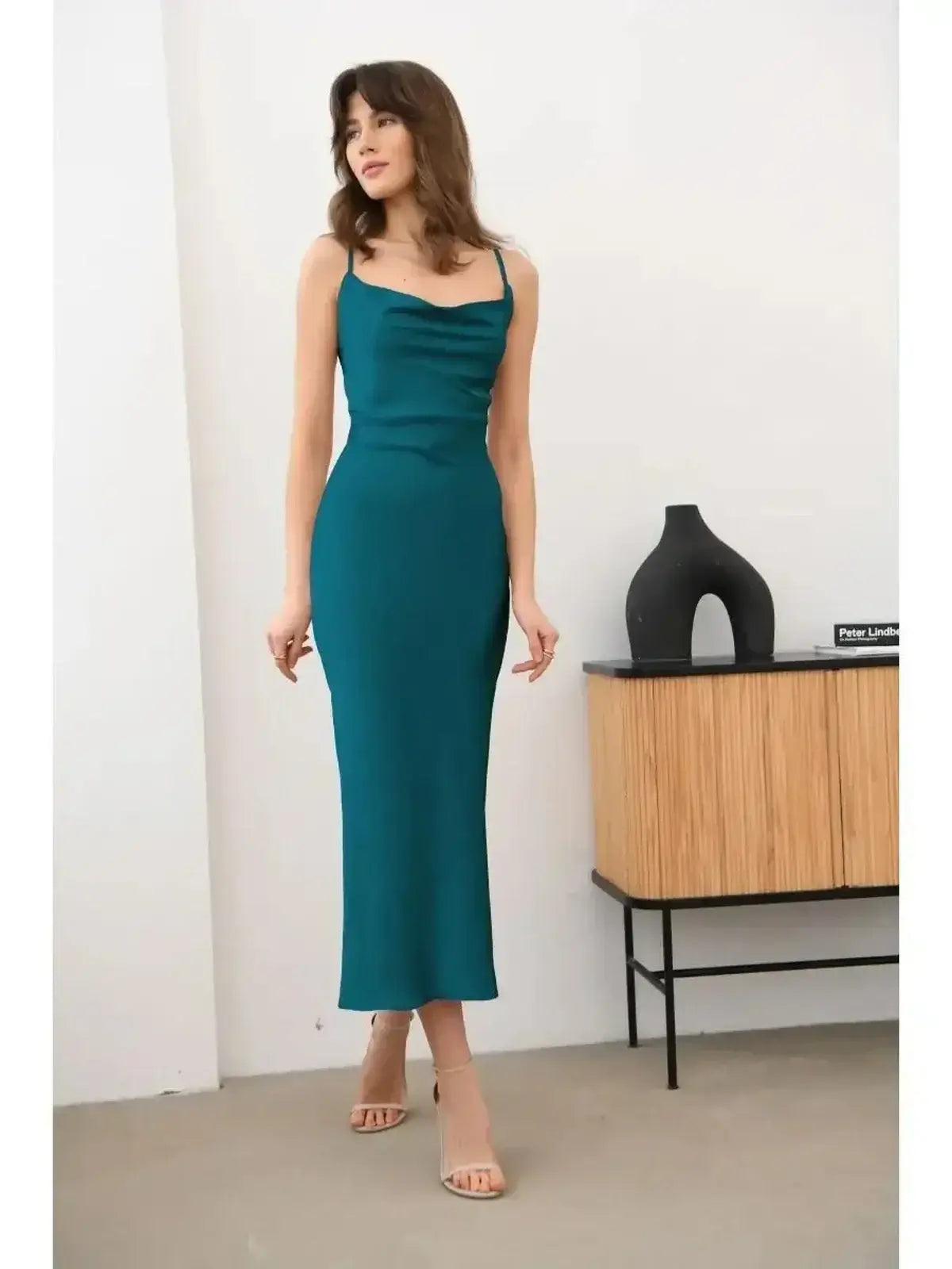 Allure Midi Dress in emerald green featuring a sleek silhouette and luxurious satin texture, perfect for elegant occasions.