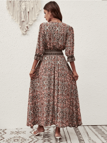Amber Muse Maxi Dress showcasing a graceful paisley motif and smocked waistband for a boho-chic look.