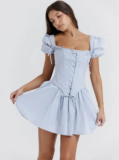 Light blue Anya Mini Dress featuring a detachable corset and puff sleeves, perfect for summer occasions and weddings.