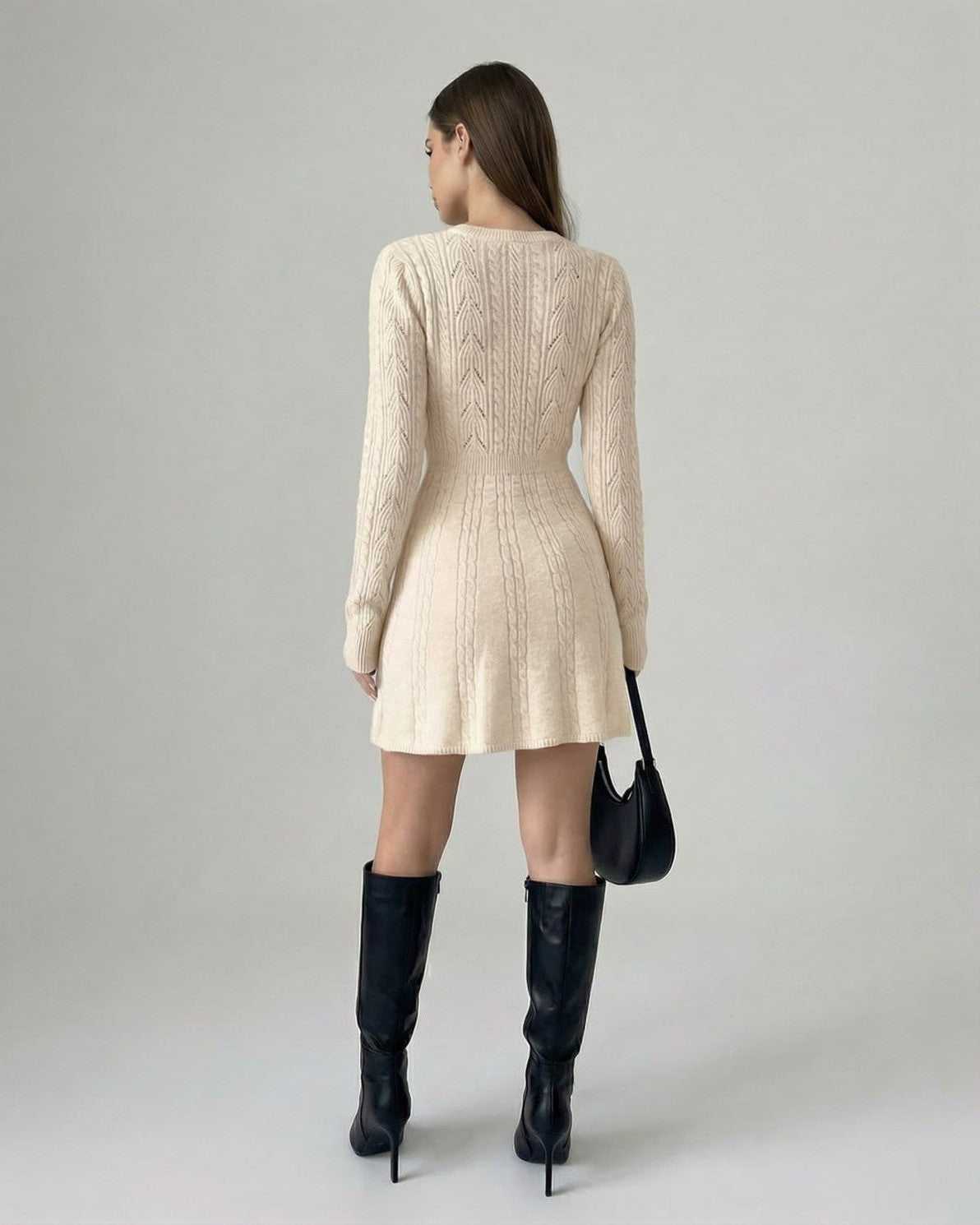 Aura Mini Dress by Lauven, showcasing a long sleeve knit design with bow detail, in soft beige, viewed from the back.