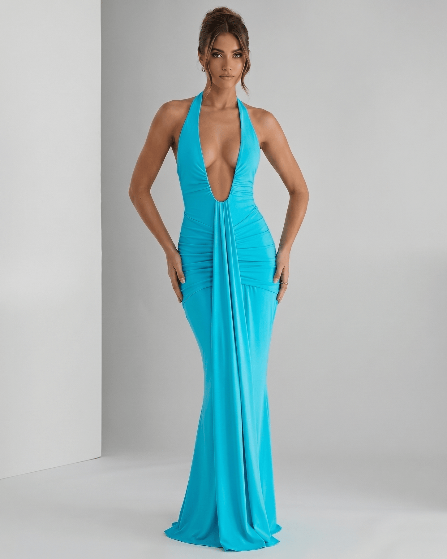 Aurelia Maxi Dress in vibrant turquoise, featuring a halter neck, smooth stretch jersey, and ruched waistline for a modern look.