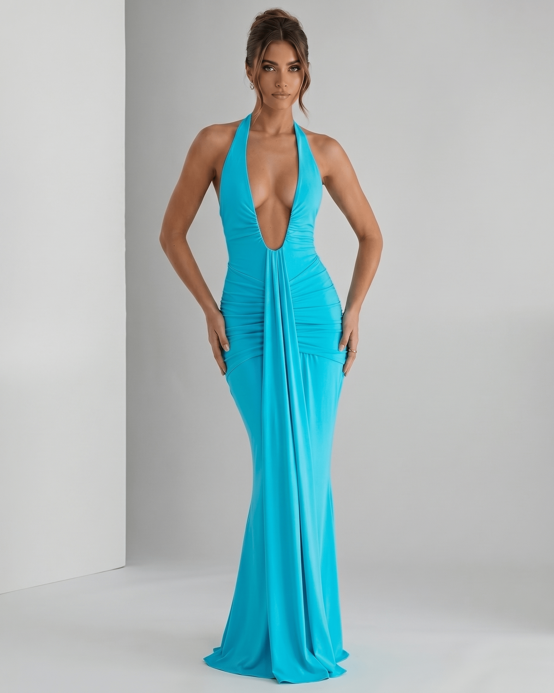 Aurelia Maxi Dress in vibrant turquoise, featuring a halter neck, smooth stretch jersey, and ruched waistline for a modern look.