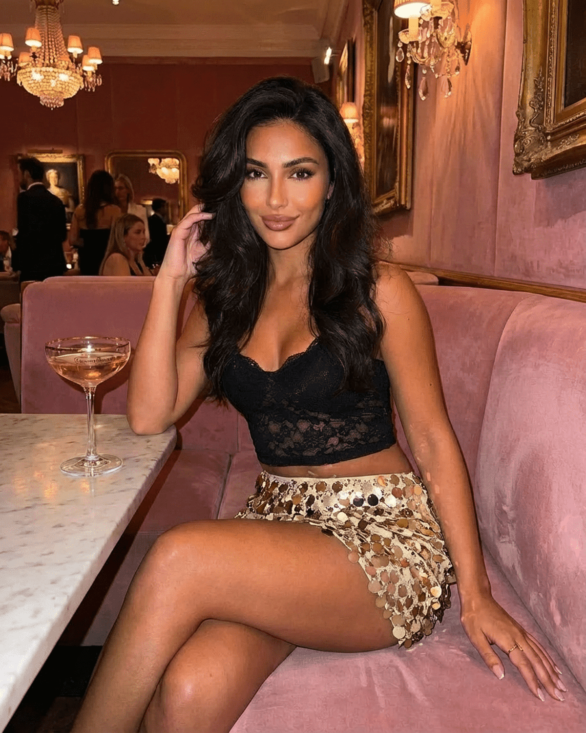 Aurelia Mini Skirt styled with a black top, showcasing gold sequin details in a chic setting by Lauven.