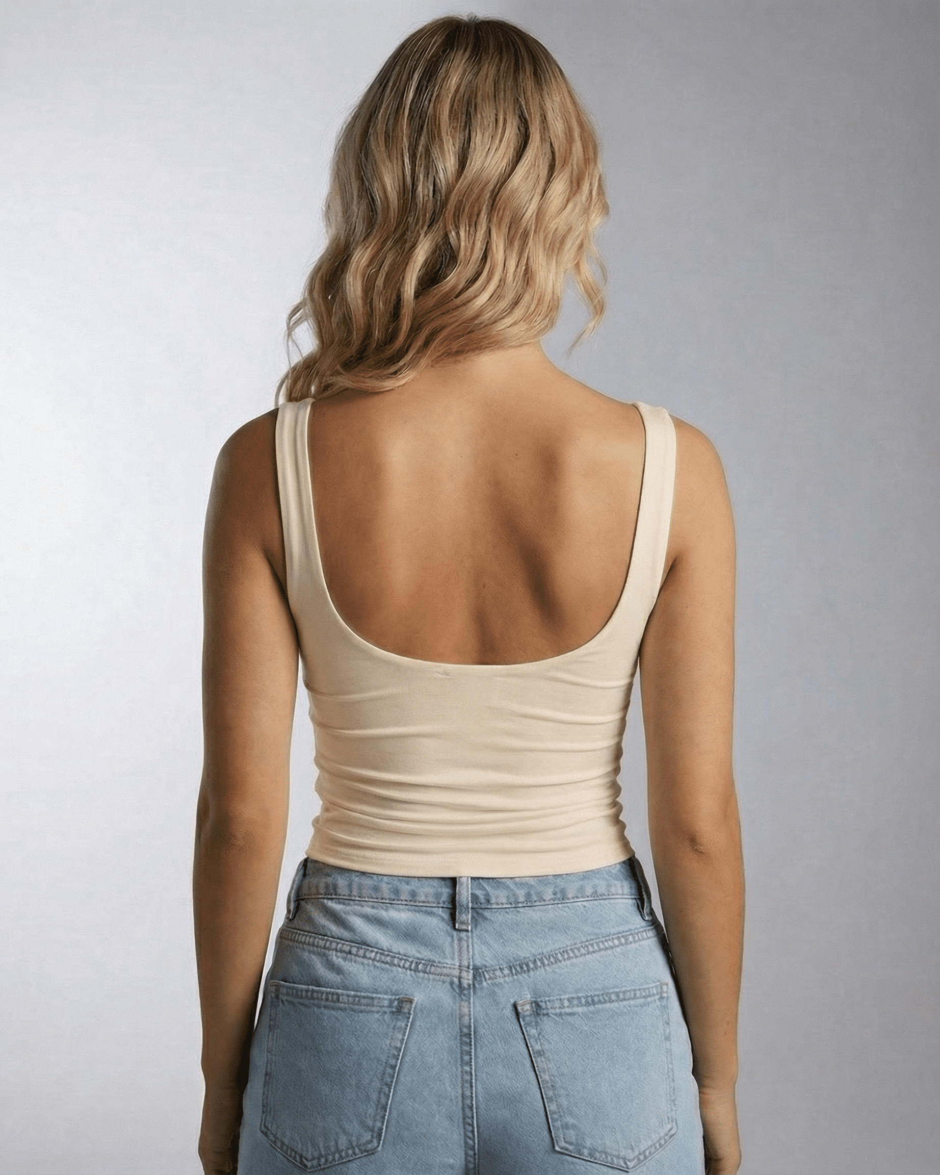 Back view of a model wearing the Aurelia Top by Lauven, showcasing its clean square neckline and sleek design.