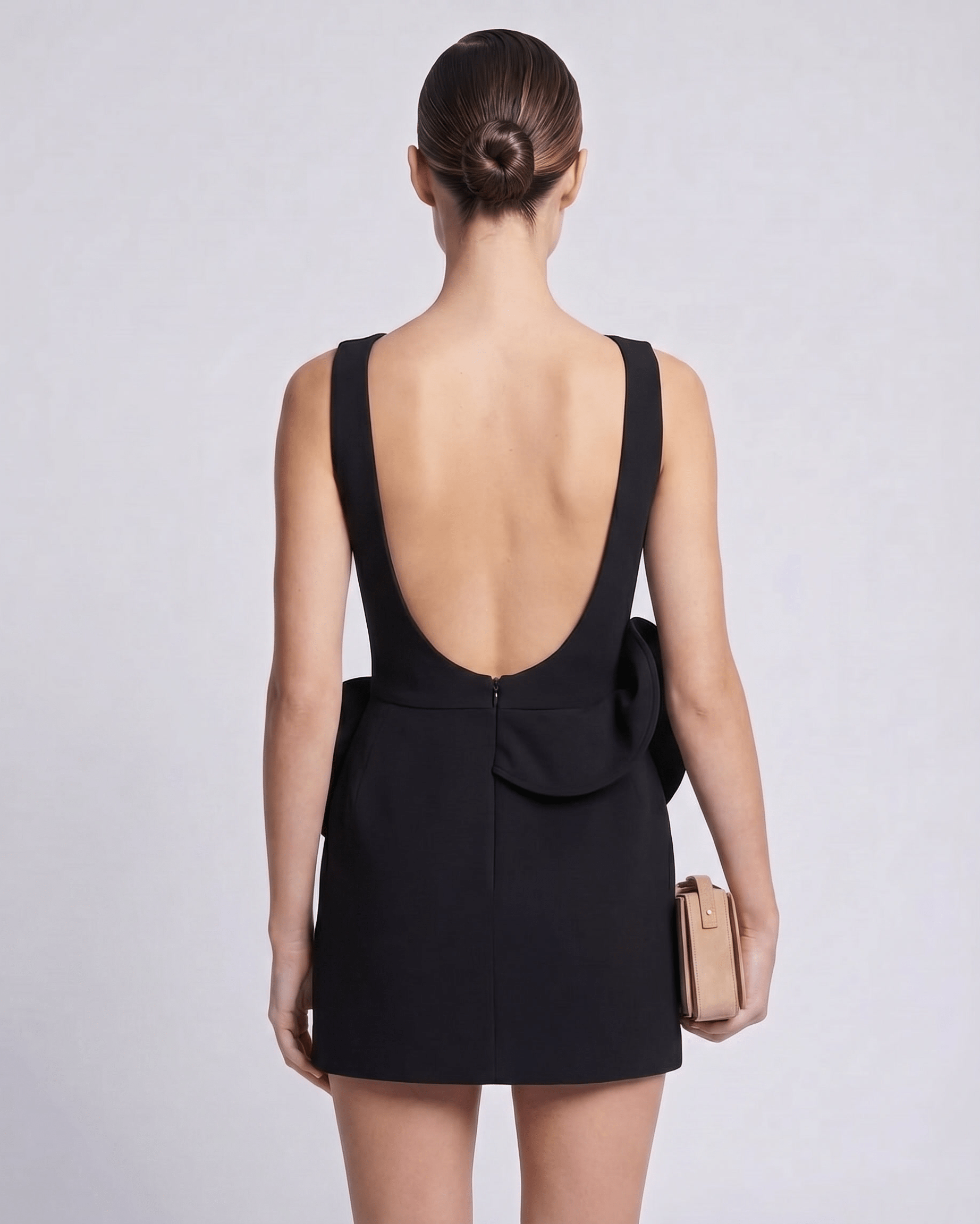 Aurelle Mini Dress in black, featuring a deep back neckline and sculptural waist detail, by Lauven.