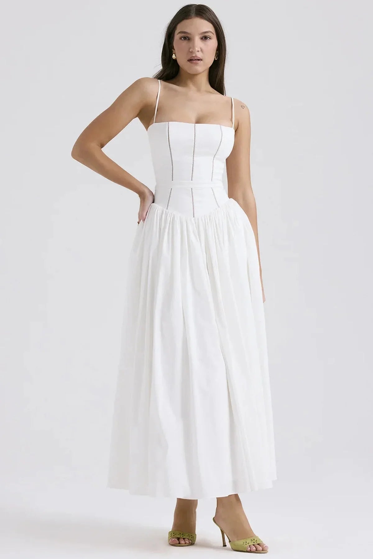 Elegant white maxi dress with fitted bodice and flowing skirt, perfect for summer weddings and formal occasions.