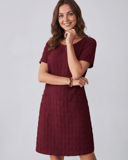Avelin Mini Dress in burgundy, featuring textured fabric, round neckline, short sleeves, and a modern silhouette by Lauven.