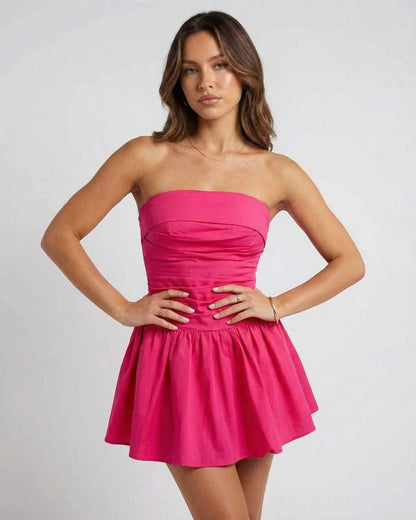 Model wearing Lauven Azalea Mini Dress in vibrant pink, strapless A-line silhouette, perfect for summer events.