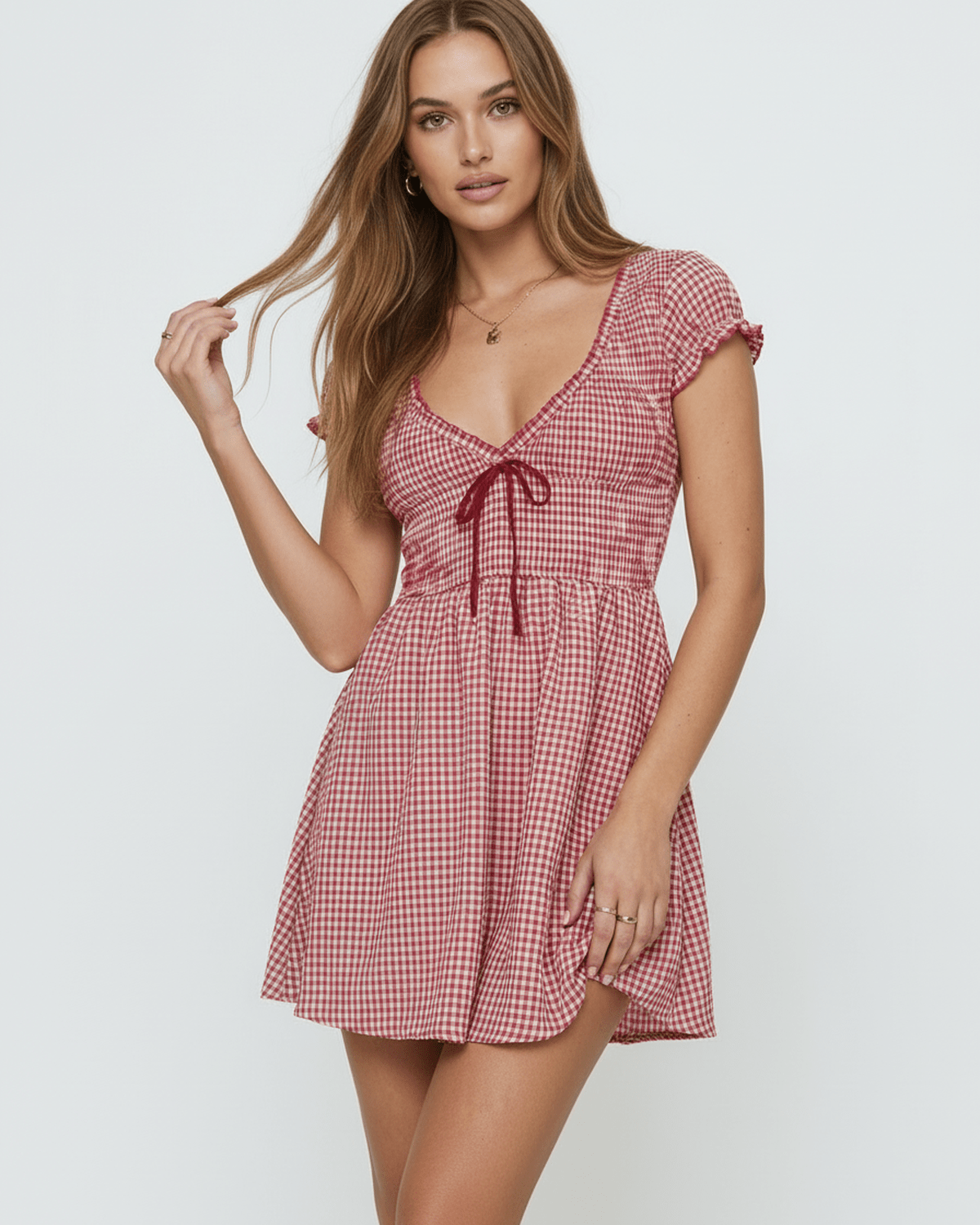 Azura Mini Dress by Lauven featuring a red checkered pattern and a flattering empire waist design.