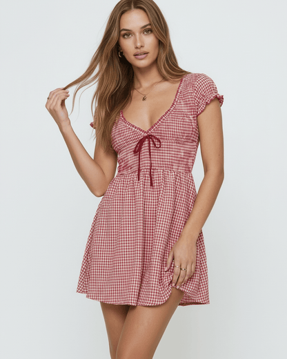 Azura Mini Dress by Lauven featuring a red checkered pattern and a flattering empire waist design.