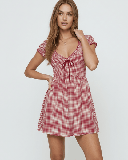 Azura Mini Dress by Lauven featuring a red checkered pattern and flattering empire waistline, perfect for autumn wear.