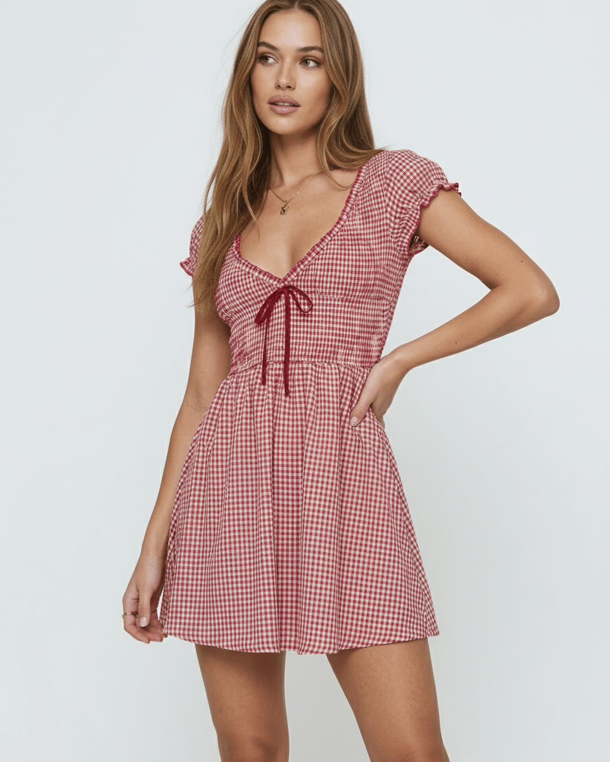 Azura Mini Dress by Lauven featuring red checkered pattern, empire waist, and sleeveless design.