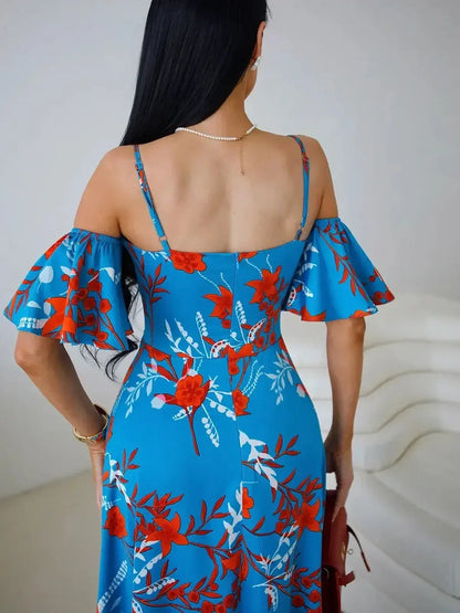 Back view of Azure Bloom Maxi Dress featuring off-shoulder ruffle sleeves and a vibrant red and white floral print.