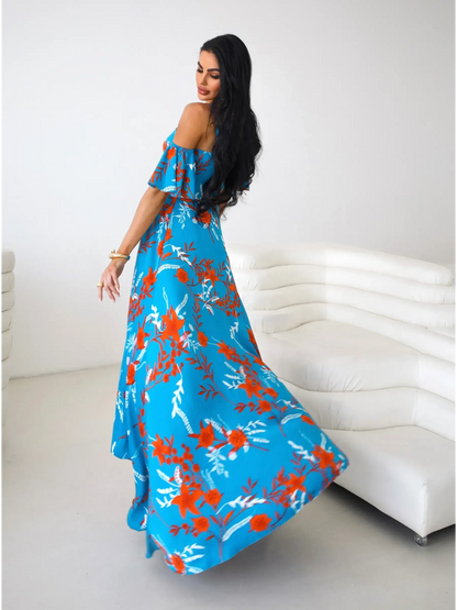 Azure Bloom Maxi Dress featuring vibrant red and white floral designs, off-shoulder ruffle sleeves, and a flowing silhouette.