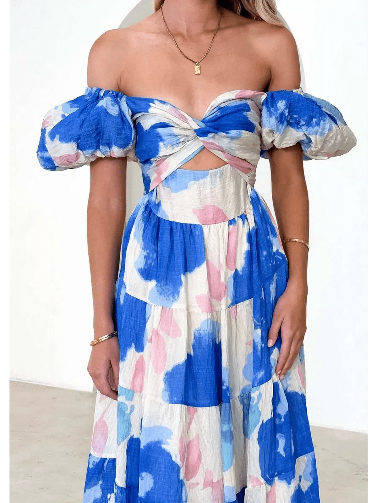Azure Bloom Maxi Dress featuring off-shoulder neckline and watercolor floral prints in blue and pink.