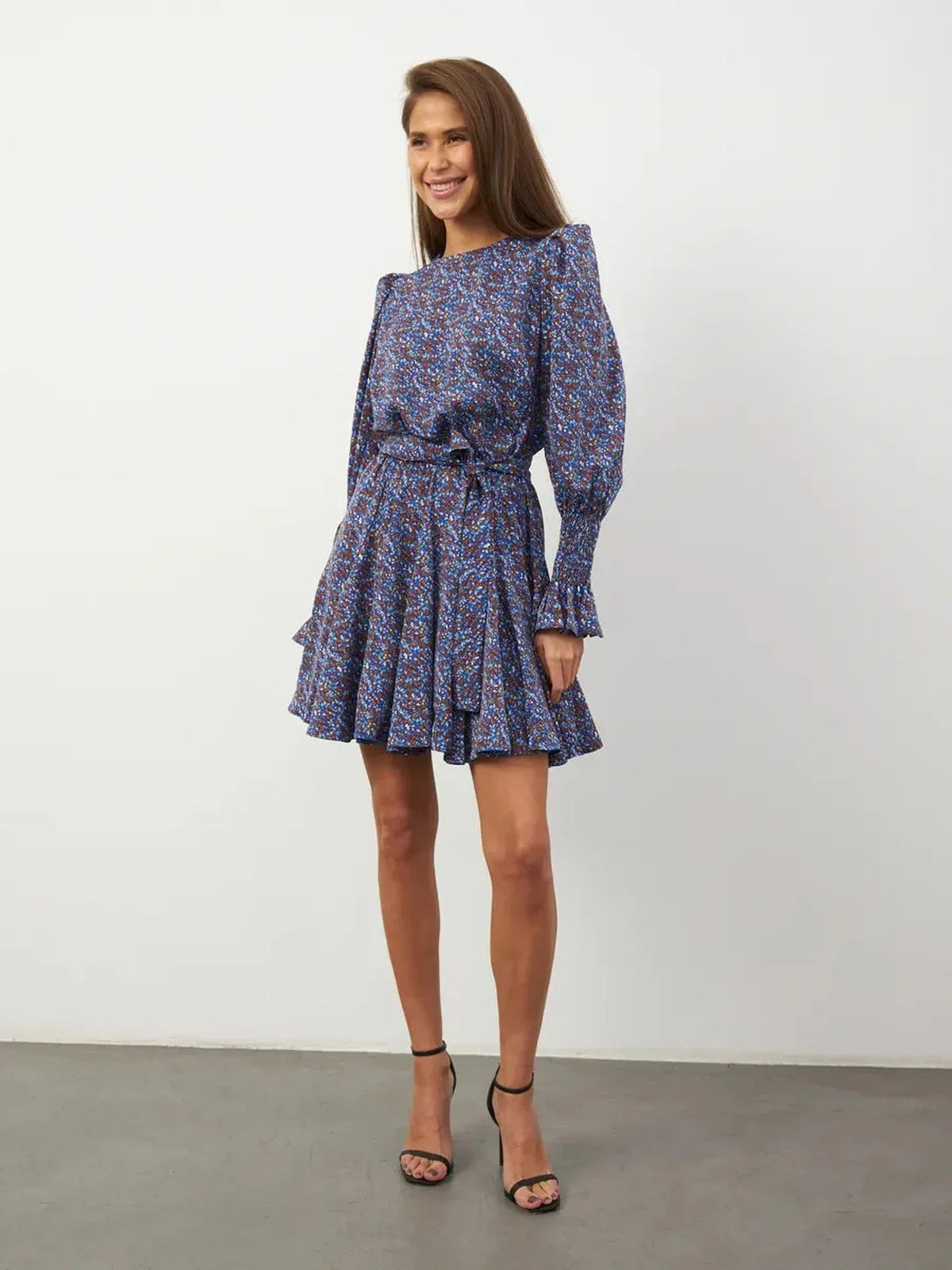 Azure Bloom Mini Dress featuring vibrant blue florals, flowing silhouette, and elegant ruffled details.