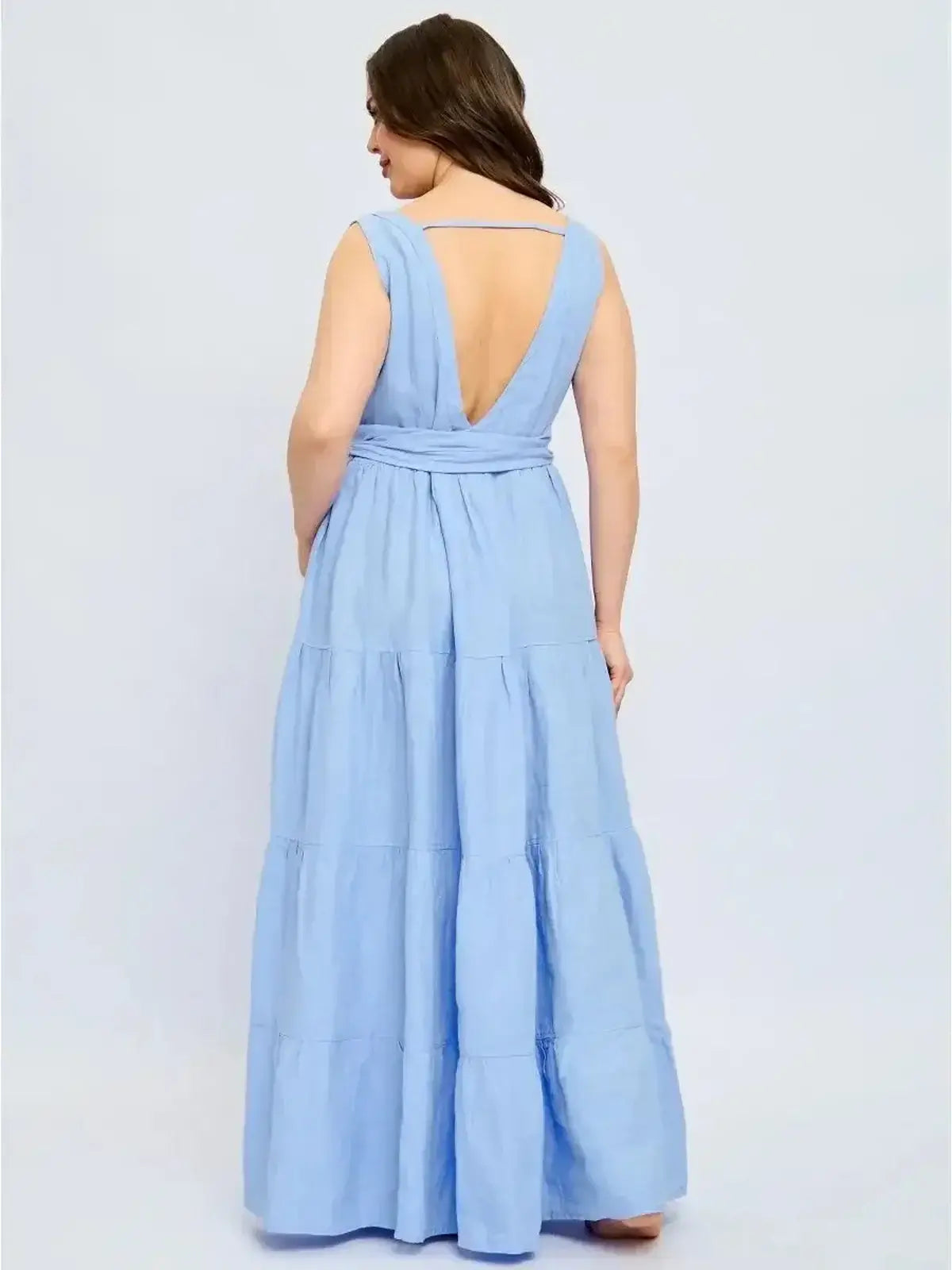 Back view of the Azure Breeze Maxi Dress in light blue, featuring a plunging V-neckline and tiered skirt.