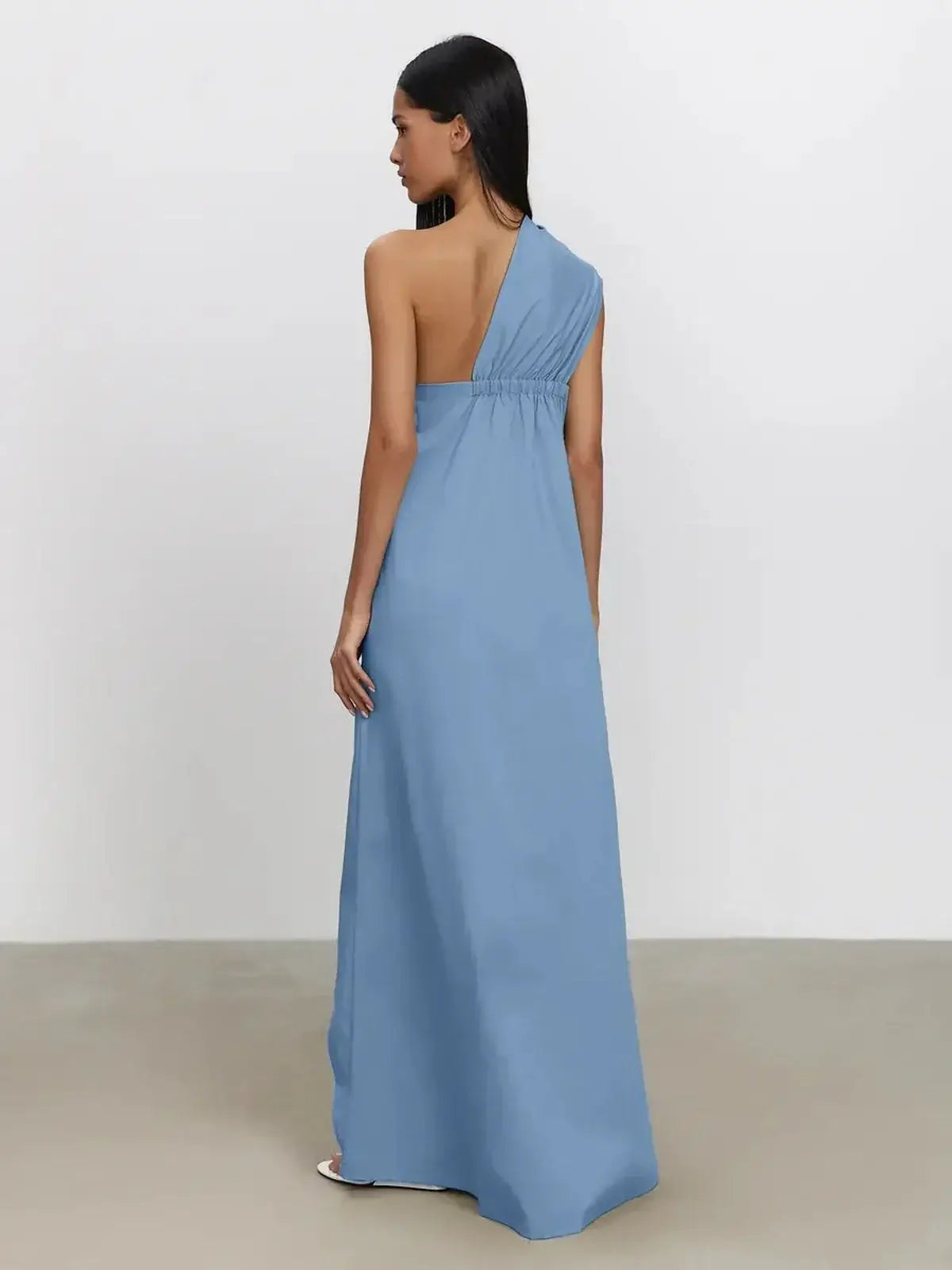 Azure Drape Maxi Dress in soft blue with an elegant one-shoulder design and fluid A-line silhouette.