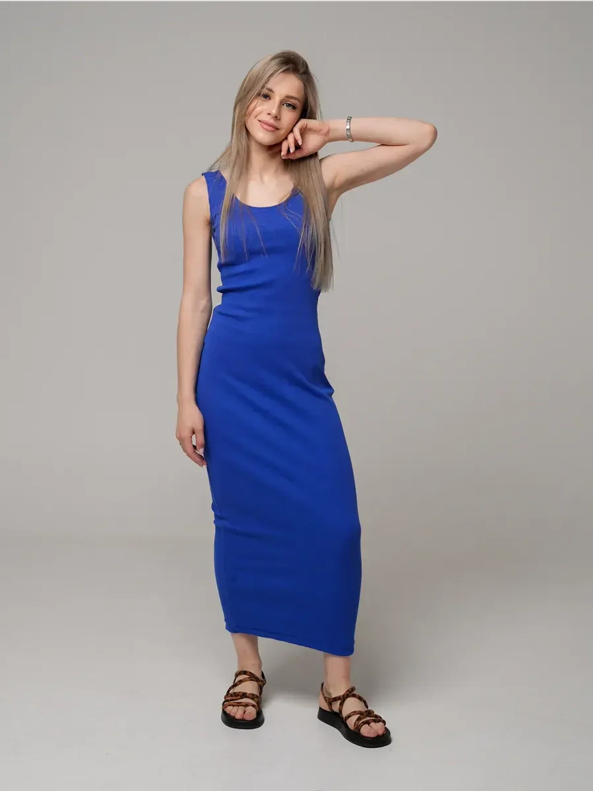 Woman wearing the Azure Elegance Maxi Dress in rich cobalt blue, showcasing a sleek ribbed silhouette and ankle-skimming length.