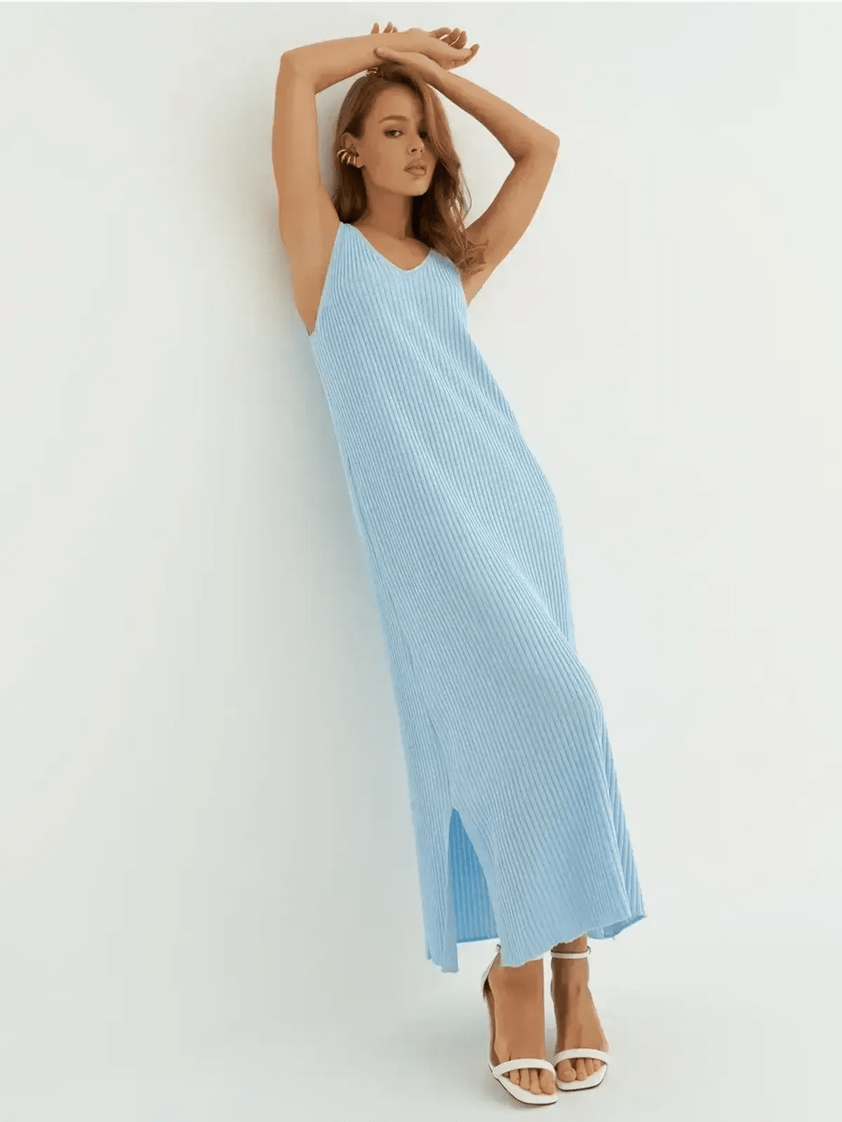 Model in a sleeveless ribbed knit azure blue maxi dress showcasing effortless elegance.
