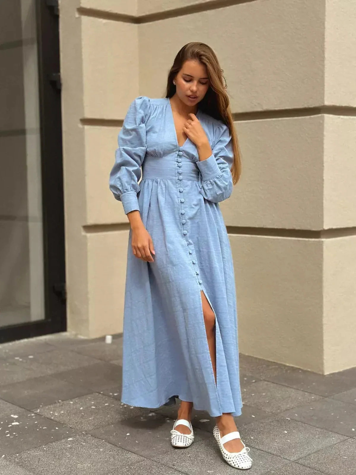 Model wearing Azure Grace Maxi Dress in light blue, featuring button detail and flowy silhouette.