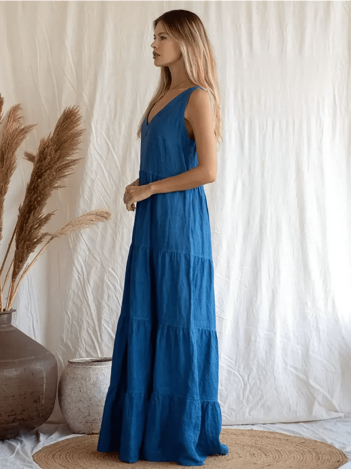 Azure Grace Maxi Dress in vibrant blue, showcasing sleeveless design and tiered skirt, perfect for elegant summer outings.