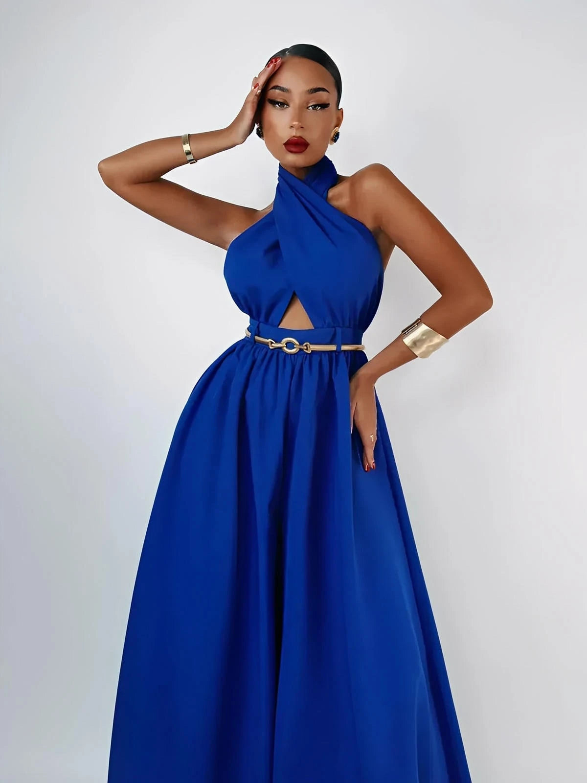 Elegant woman modeling an Azure Halter Jumpsuit with wide leg silhouette and bold open-back design.