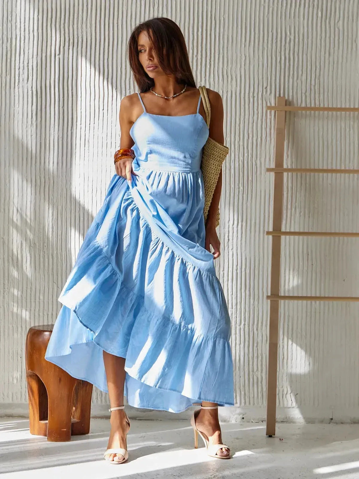 Azure Muse Maxi Dress in sky-blue cotton, backless design, showcasing breezy summer elegance.