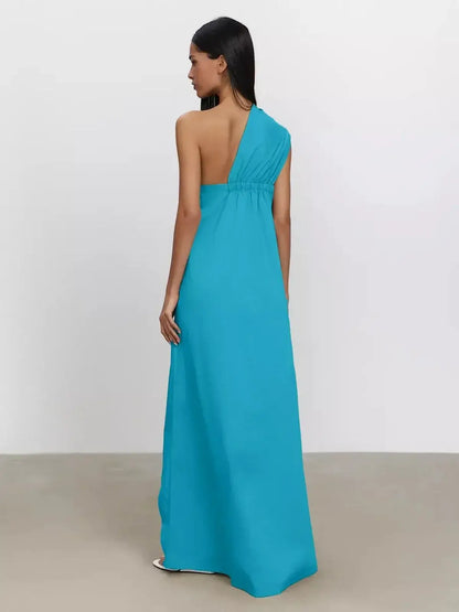 Back view of the Azure Sway Maxi Dress in vibrant turquoise, showcasing one-shoulder design and flowy A-line cut.