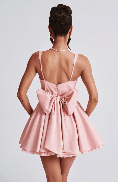 Pink Barbie Mini Dress featuring a corset bodice and a large bow detail on the back, perfect for special occasions.