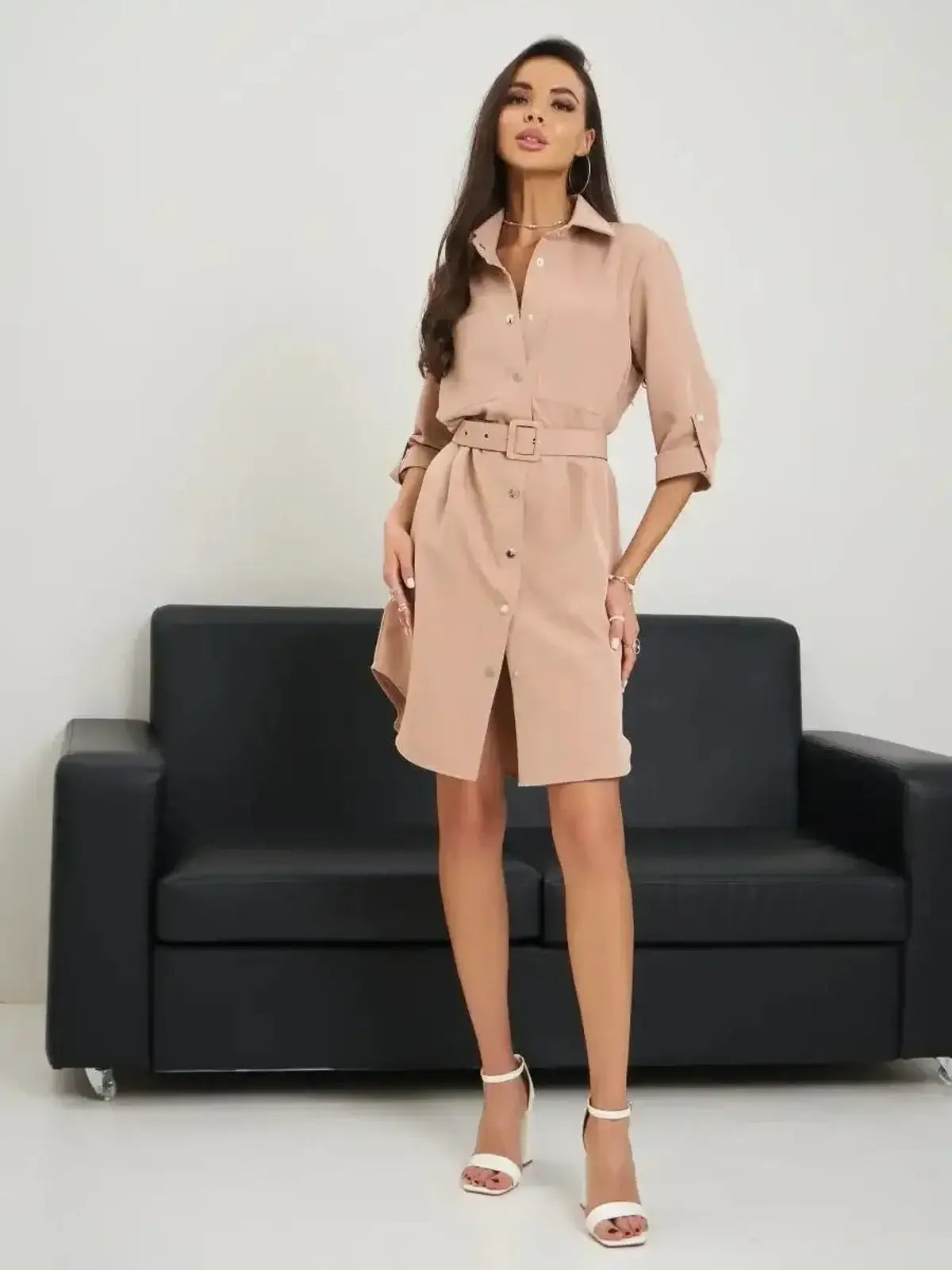 Chic belted mini dress in soft beige, designed for summer style, with a crisp collar and snap-button closure.