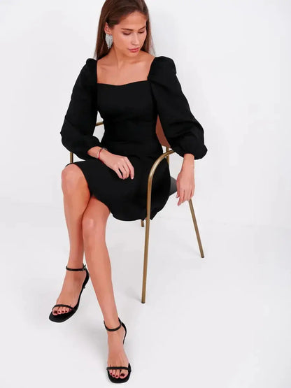 Elegant black mini dress with puff sleeves and square neckline, perfect for weddings and cocktail parties.