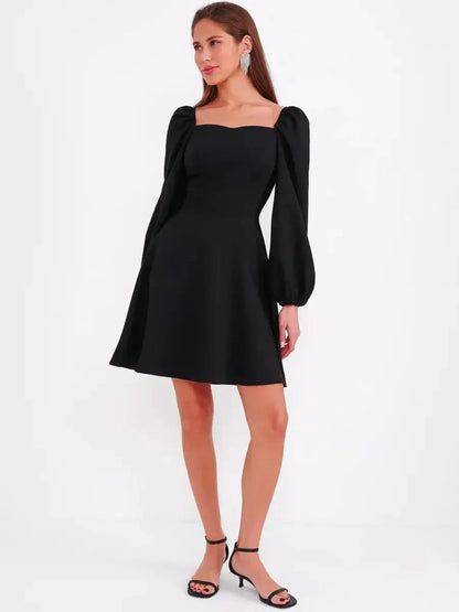 Black mini dress with sculpted bodice and puff sleeves, perfect for cocktail or formal occasions.