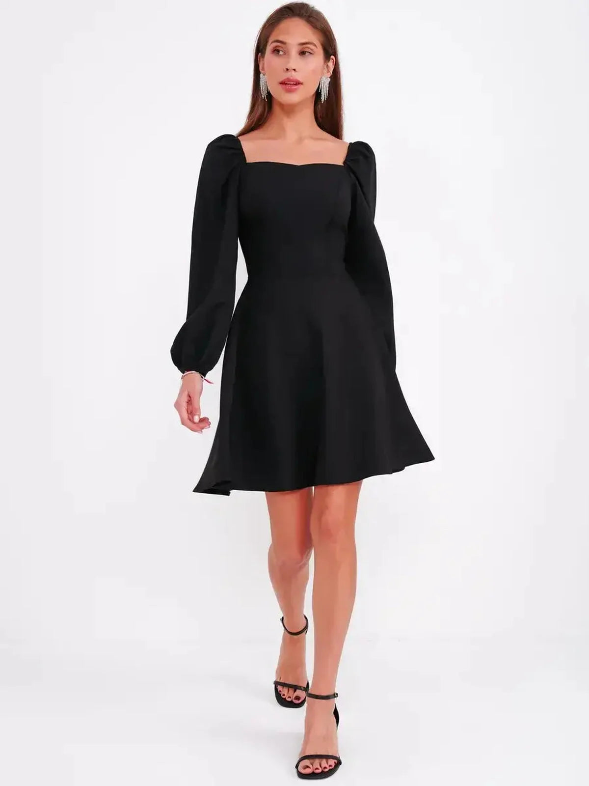 Black mini dress with puff sleeves and square neckline, perfect for wedding guest or cocktail events.