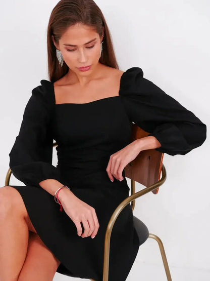 Elegant black mini dress with puff sleeves and square neckline, perfect for weddings and parties.