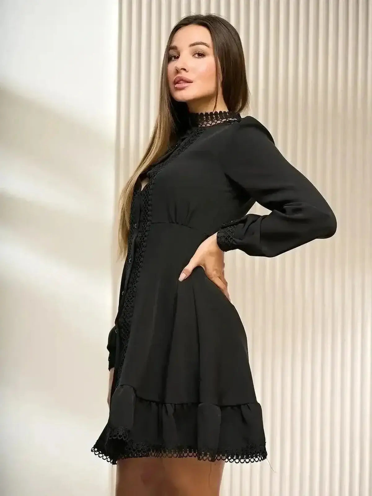 Elegant black mini dress with lace trim and flared hem, perfect for formal and cocktail events.