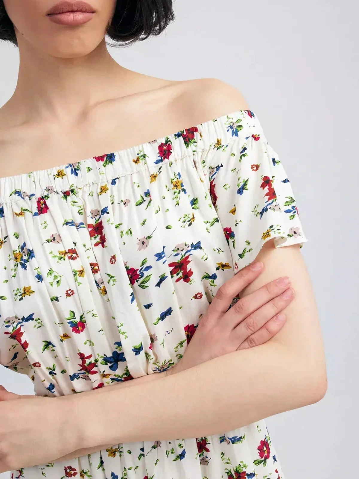 Bloom Off-Shoulder dress showcasing floral print and off-shoulder neckline, perfect for summer elegance.