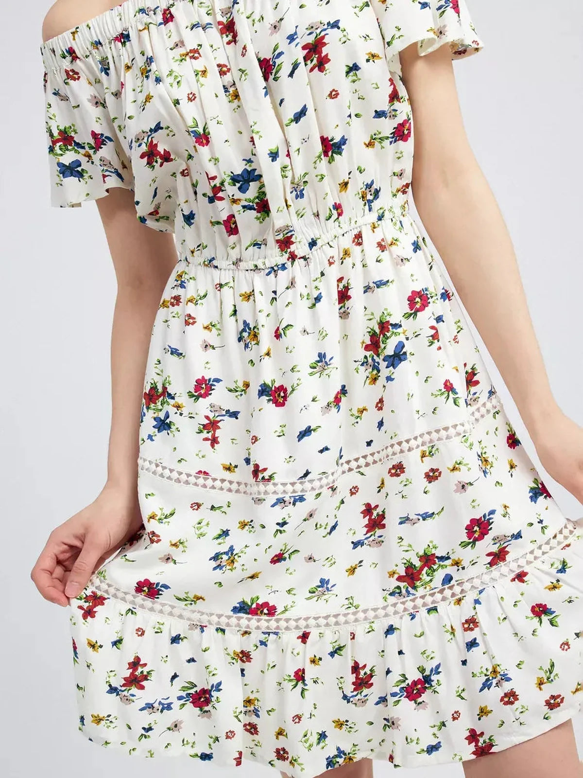 Bloom Off-Shoulder summer dress featuring multicolor floral print and embroidered trims, highlighting a relaxed fit.