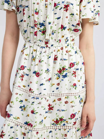 Close-up of Bloom Off-Shoulder dress featuring multicolor floral print and lace trim details.