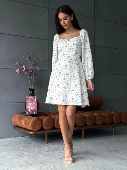 Elegant white summer dress with delicate floral print, perfect for weddings, parties, and casual outings.